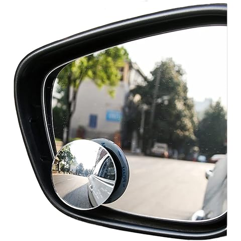 Round convex mirror attached to a car side mirror with a view of a street.