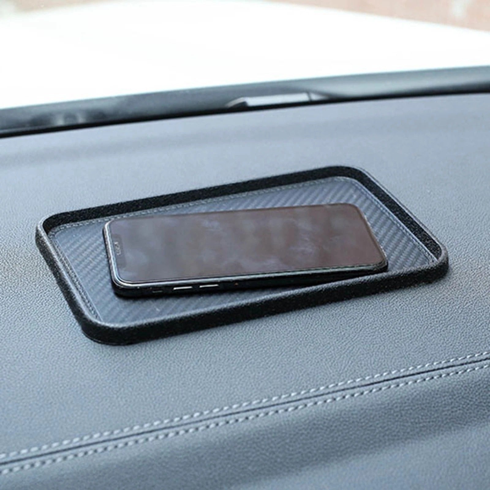 Phone on a black car mount on a car dashboard