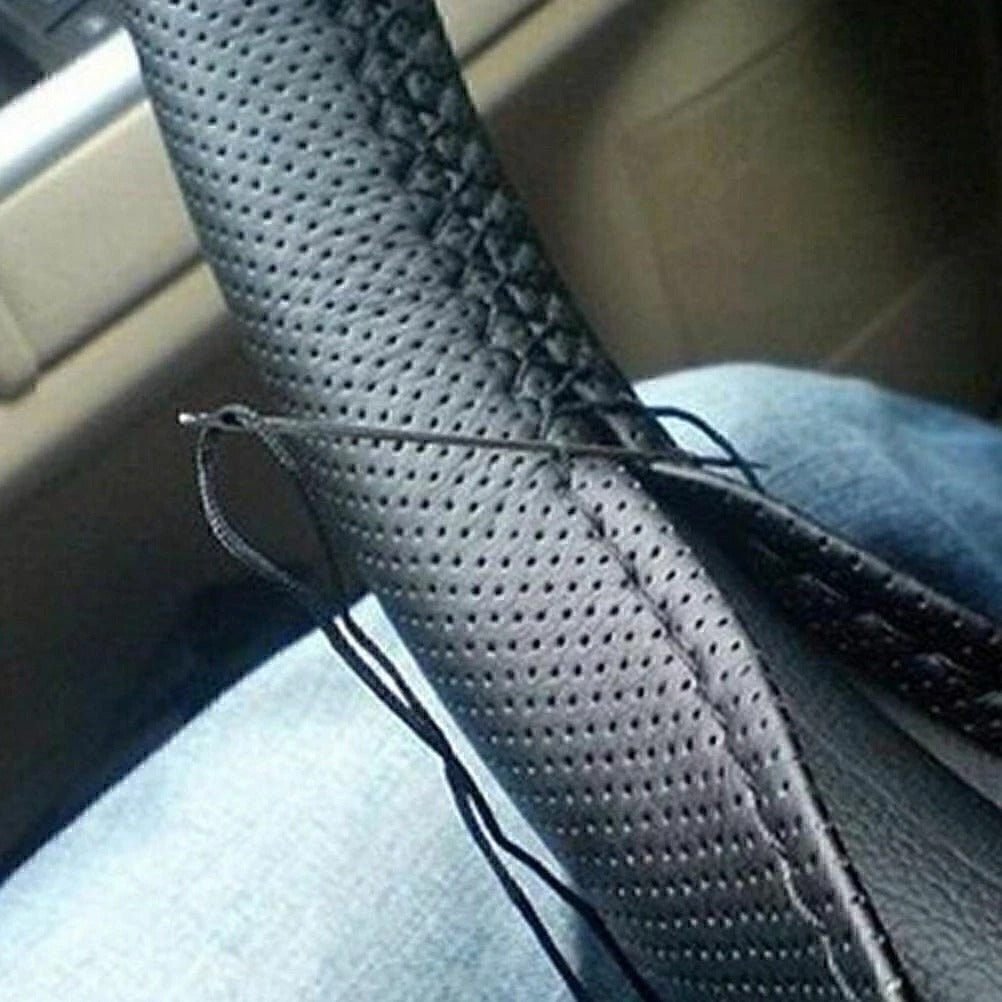 Close-up of a car seat with a textured gray cover and visible stitching.